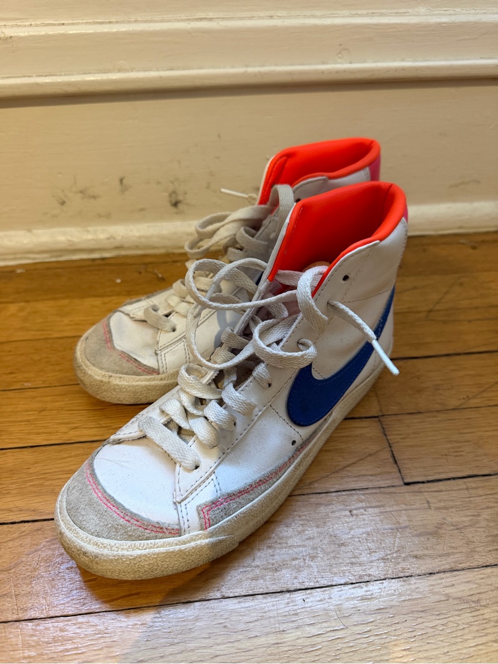 Nike Blazer High-Top Sneakers in White with Blue Swoosh and Bright Orange Lining